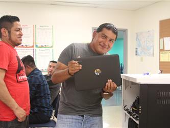 Student smiling with Chrombook