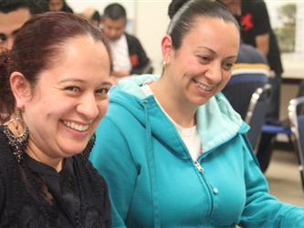 Two female students share a laugh