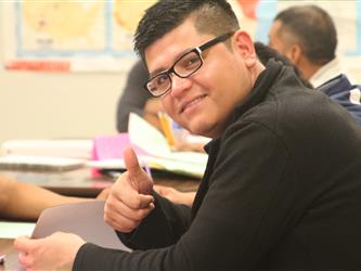 Student gives thumbs up during lesson