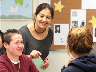 close up of teacher with two students at table